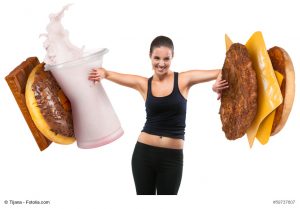 Fit young woman pushing fast food