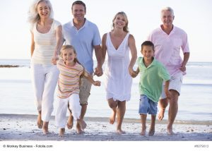 Extended family walking on beach